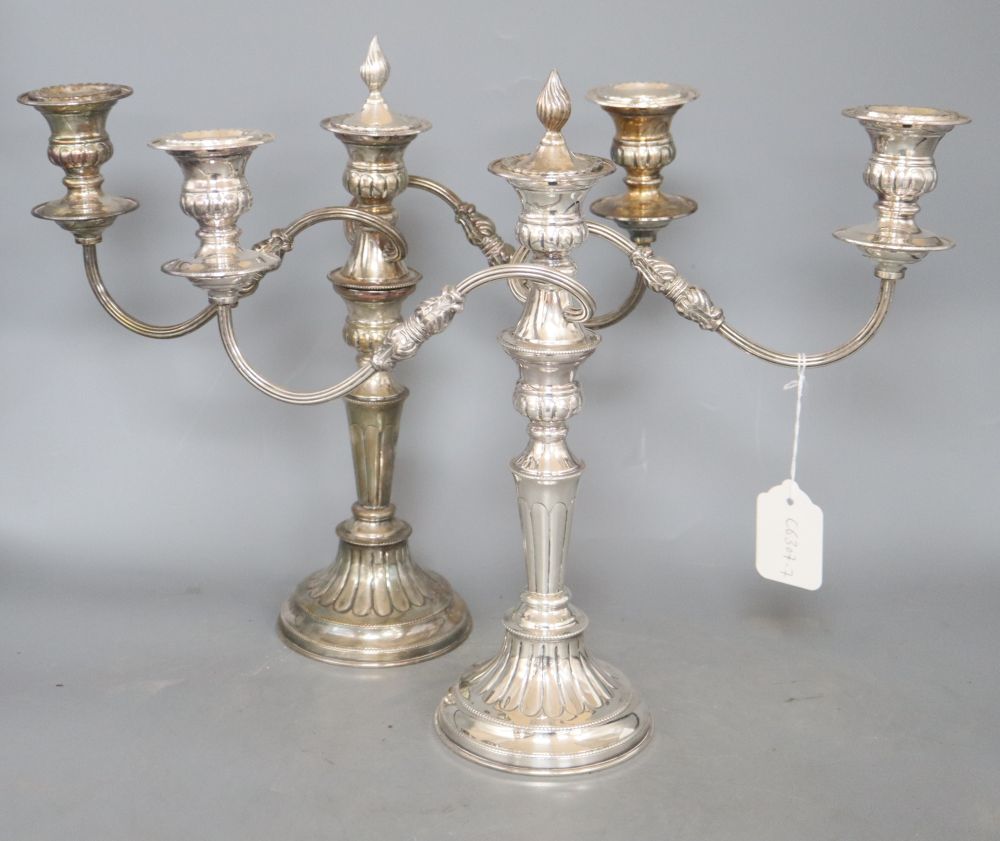 A pair of plated two branch candelabra